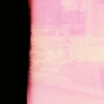 a blurry photo of a person walking down a street