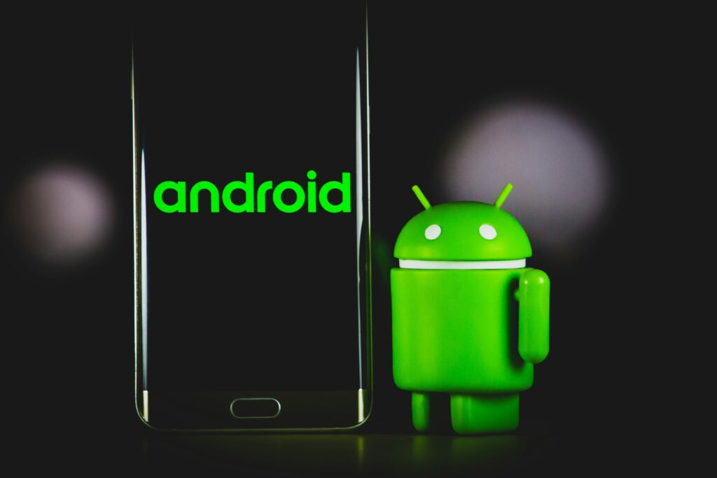 Current image: green frog iphone case beside black samsung android smartphone
