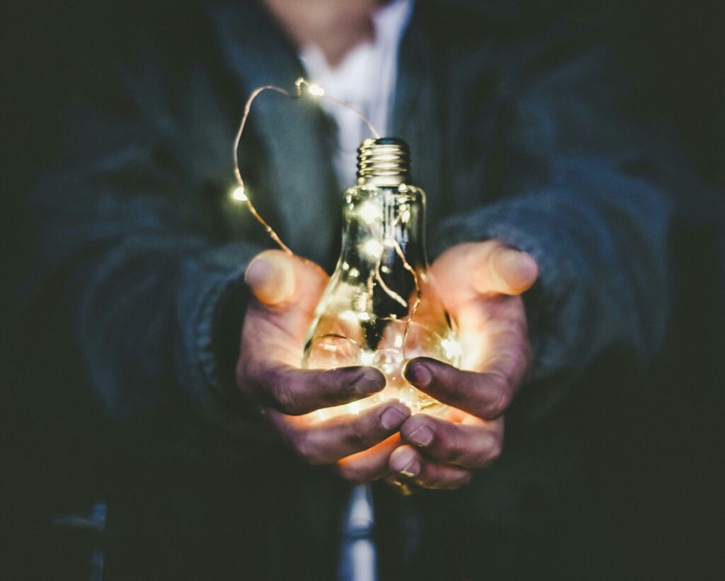 Current image: man holding incandescent bulb
